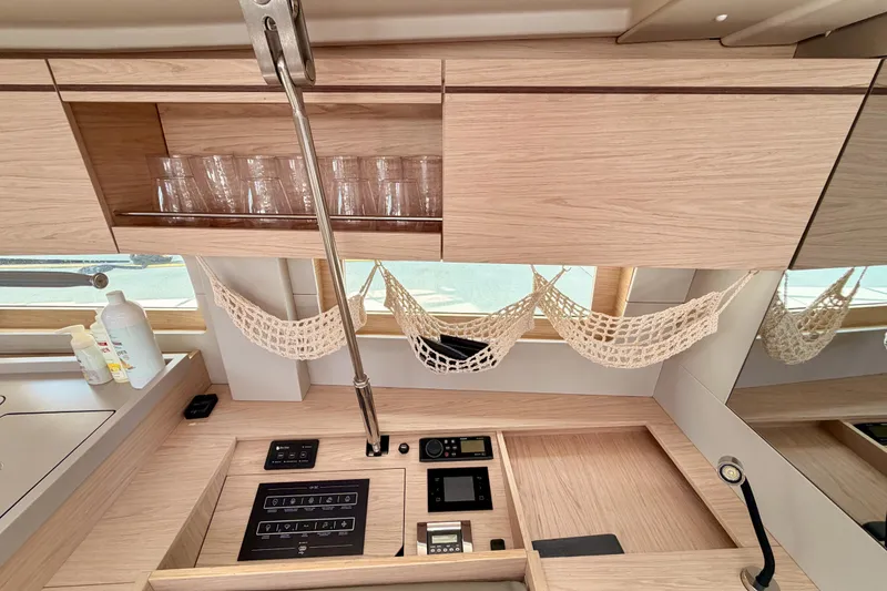 Slide: The Image of Modern kitchen interior of 2020 Beneteau Oceanis 51.1 yacht with wooden cabinets and glassware. - 67