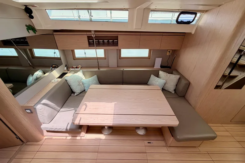 Slide: The Image of Modern interior of 2020 Beneteau Oceanis 51.1 yacht with cozy seating and wooden table. - 69