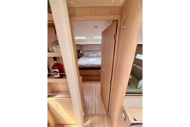Slide: The Image of Interior of 2020 Beneteau Oceanis 51.1 yacht, featuring a cozy cabin and wooden finishes. - 71