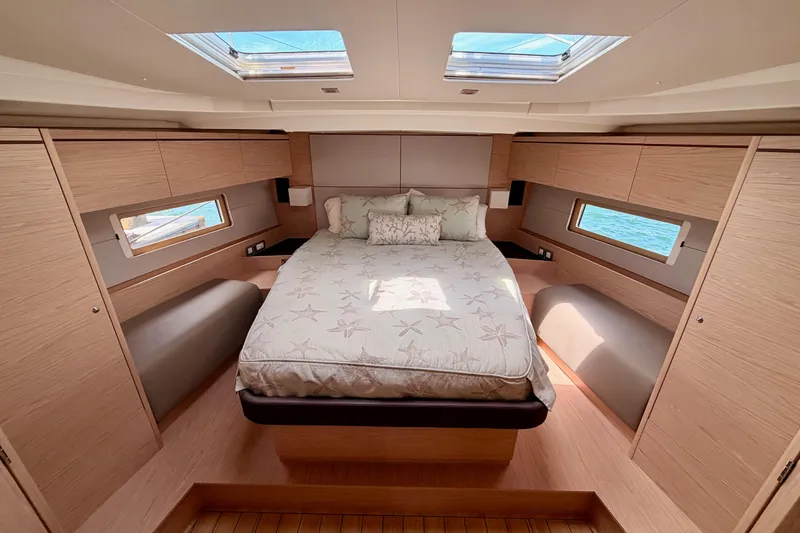 Slide: The Image of Luxurious cabin interior of 2020 Beneteau Oceanis 51.1 yacht with skylights and wood finish. - 72
