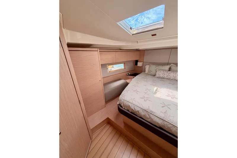 Slide: The Image of Luxurious cabin interior of 2020 Beneteau Oceanis 51.1 yacht with skylight and cozy bedding. - 74