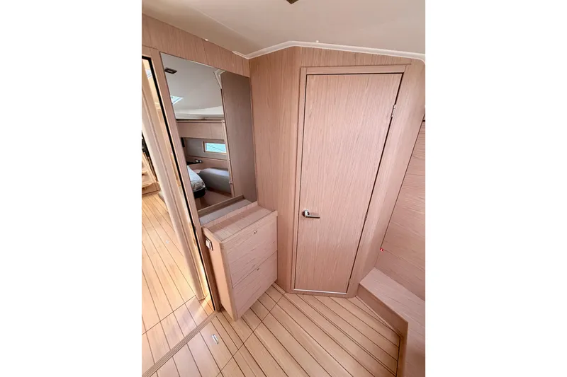 Slide: The Image of Interior of 2020 Beneteau Oceanis 51.1 yacht, featuring sleek wood paneling and modern design. - 76