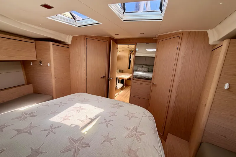 Slide: The Image of Luxurious interior of 2020 Beneteau Oceanis 51.1 yacht, featuring elegant wood finishes and spacious cabin. - 79