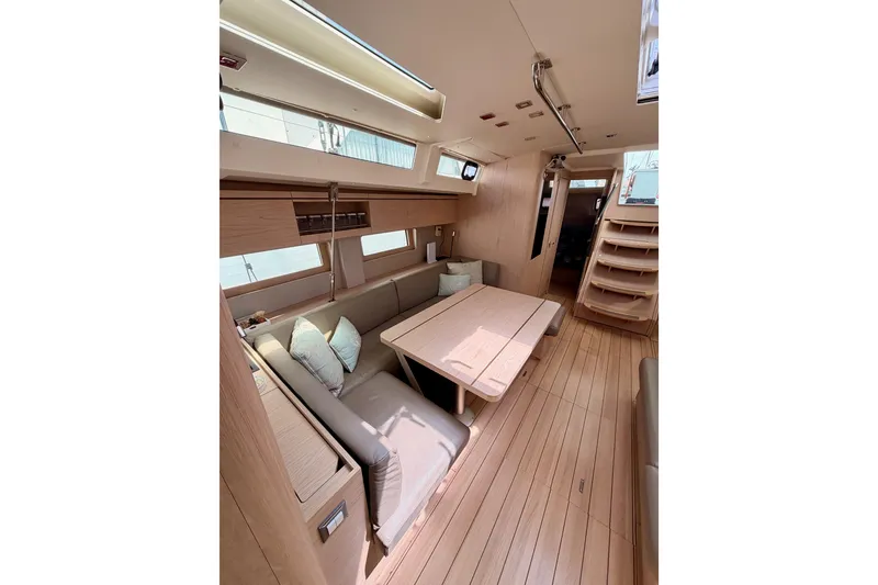 Slide: The Image of Interior of 2020 Beneteau Oceanis 51.1 yacht, featuring elegant wood finish and spacious seating area. - 80