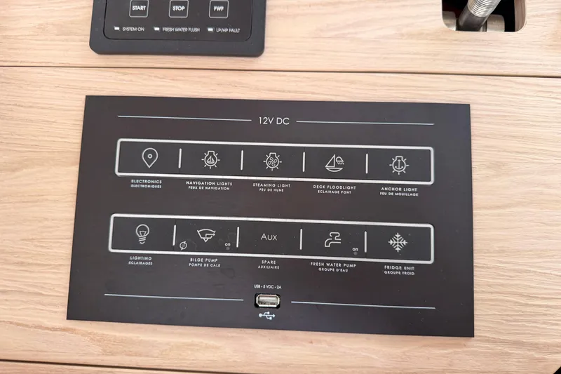 Slide: The Image of Control panel of a 2020 Beneteau Oceanis 51.1 yacht, featuring 12V DC system functions. - 87