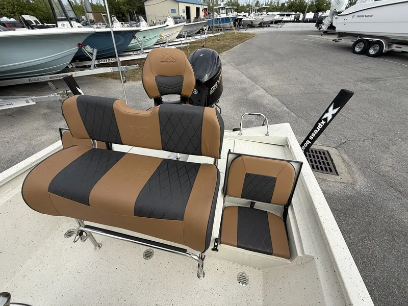 Slide: The Image of 2026 Xpress Hyper-Lift Bay Series boat with cushioned seats. - 13