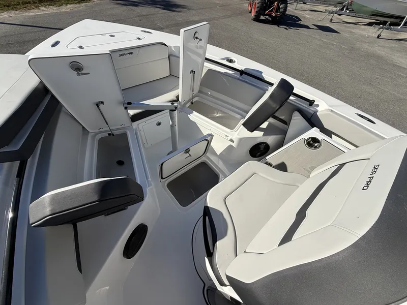 Slide: The Image of 2026 Sea Pro 245FLX boat interior with seating and storage. - 6