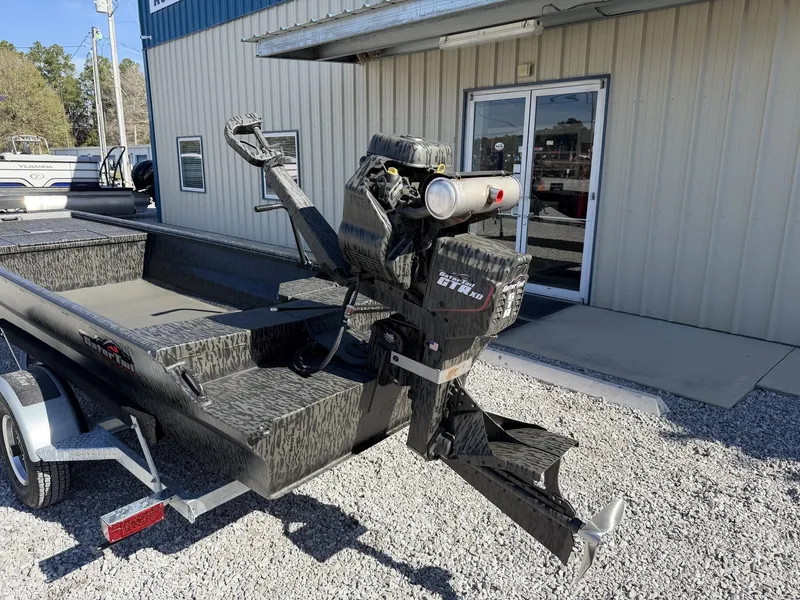 Slide: The Image of Gator Tail Gator Series 17 x 48 boat, 2026 model, parked outside a building. - 7