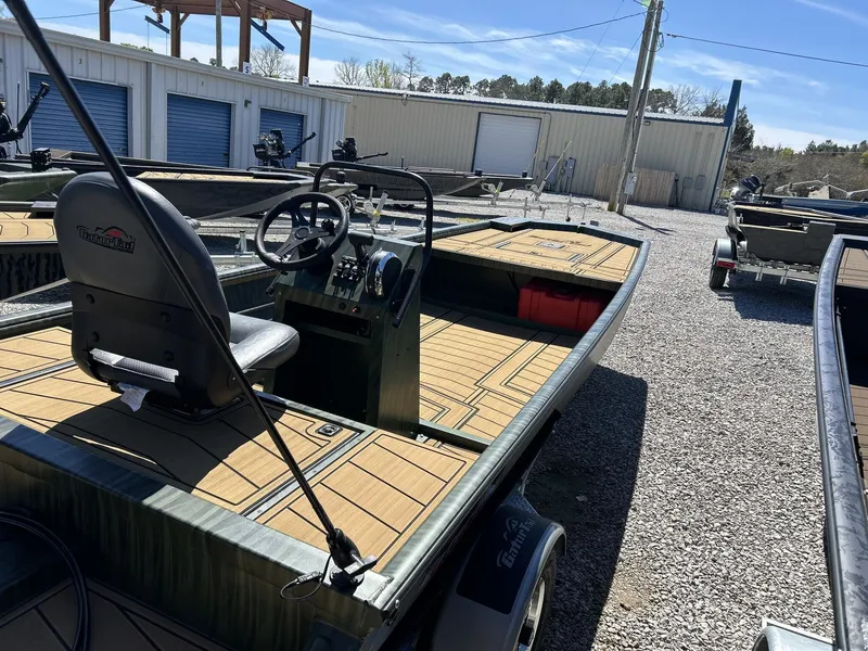 Slide: The Image of Gator Tail Extreme Series 20x60 CC boat, 2026 model, on gravel lot. - 3