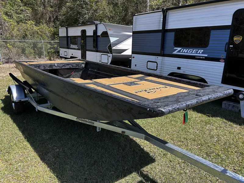 Slide: The Image of 2026 Gator Tail Extreme Series 1754 boat on trailer beside RV. - 5