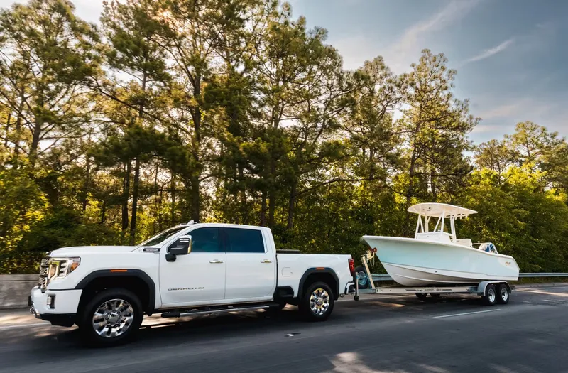 Slide: The Image of 2026 Sea Hunt Ultra 229 on trailer behind white truck. - 14