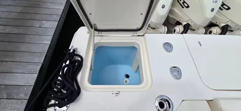 Slide: The Image of 2024 Grady-White Canyon 386 boat with open storage compartment at dock. - 12