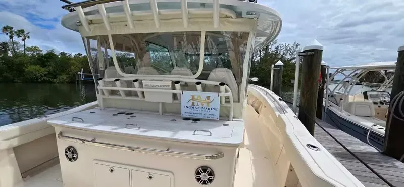 Slide: The Image of 2024 Grady-White Canyon 386 boat docked, serene water setting. - 16