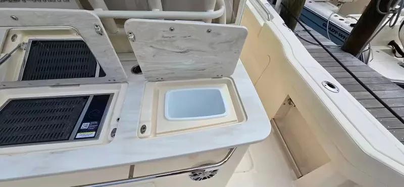 Slide: The Image of 2024 Grady-White Canyon 386 boat with open storage compartment. - 20
