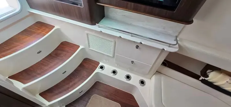 Slide: The Image of Interior of 2024 Grady-White Canyon 386 with wooden steps and storage. - 23