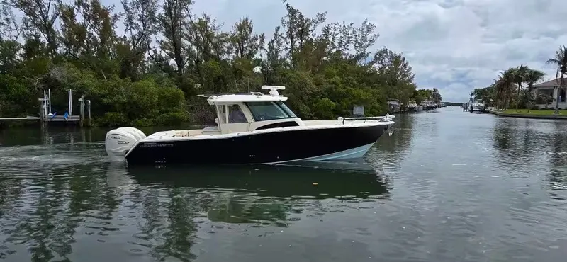 Slide: The Image of 2024 Grady-White Canyon 386 boat on calm water. - 4