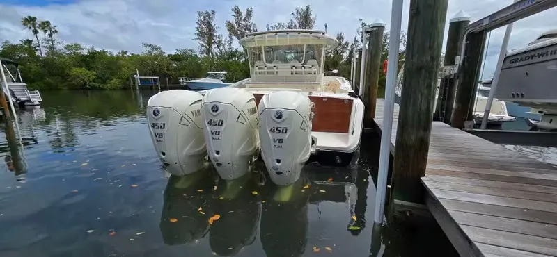 Slide: The Image of 2024 Grady-White Canyon 386 with triple Yamaha 450 V8 engines at dock. - 7