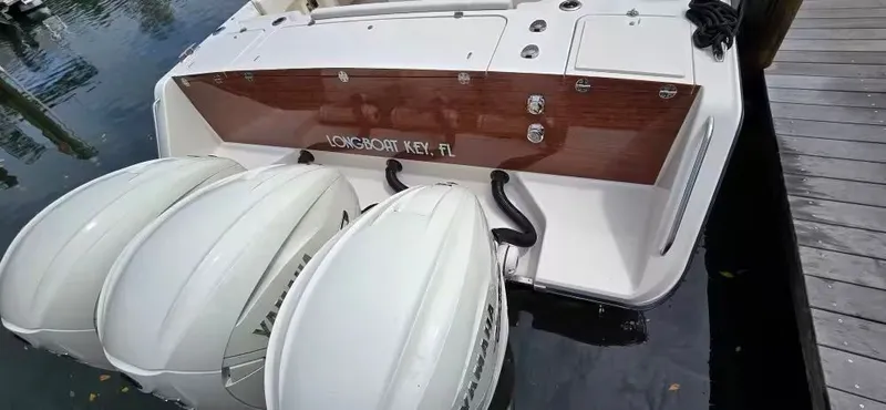 Slide: The Image of 2024 Grady-White Canyon 386 boat with triple outboard engines at dock. - 9