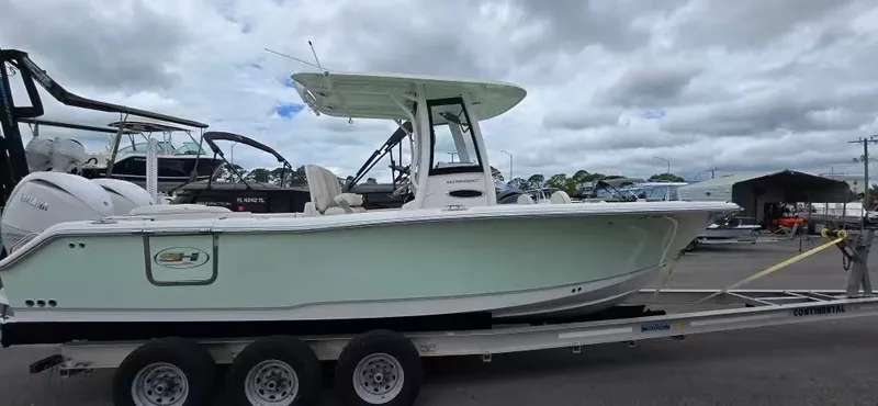 The Image of Sea Hunt 265 Ultra 2025 on trailer at marina. - 1