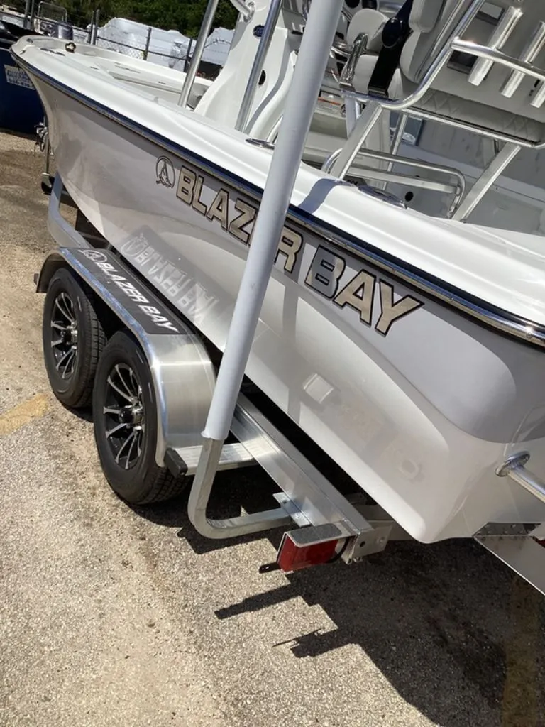 Slide: The Image of 2026 Blazer PureBay 2200 boat on trailer, side view. - 13