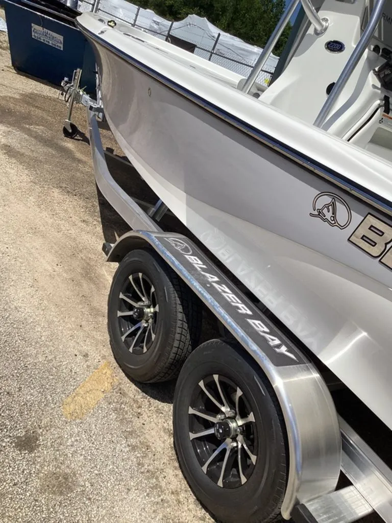 Slide: The Image of 2026 Blazer PureBay 2200 boat on trailer, side view. - 14