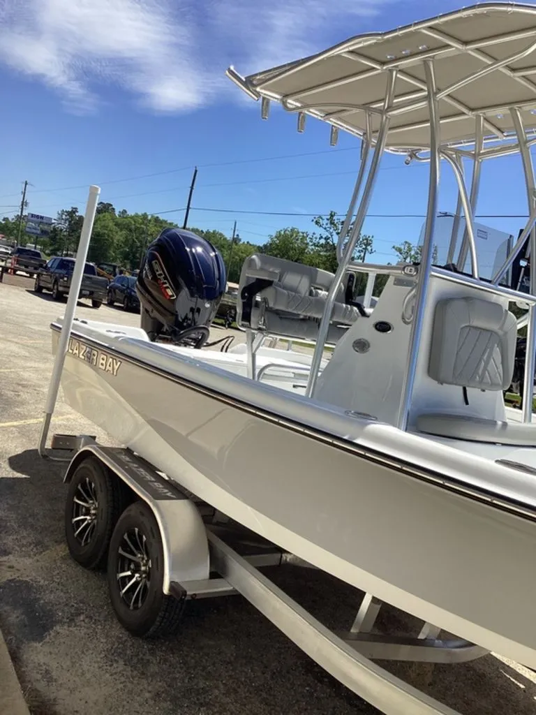 Slide: The Image of 2026 Blazer PureBay 2200 boat on trailer outdoors. - 21