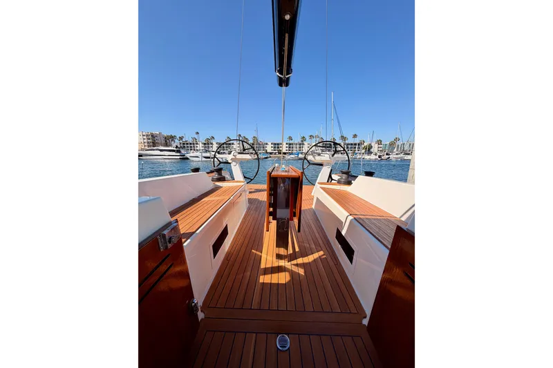 Slide: The Image of 2017 Solaris 50 yacht with wooden deck, docked in a marina under clear blue skies. - 113