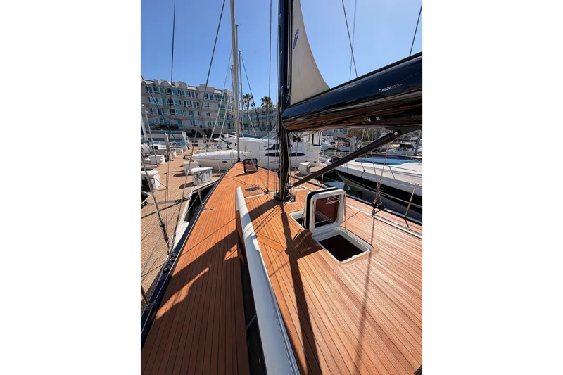 Slide: The Image of Luxurious 2017 Solaris 50 yacht with sleek wooden deck in marina setting. - 17