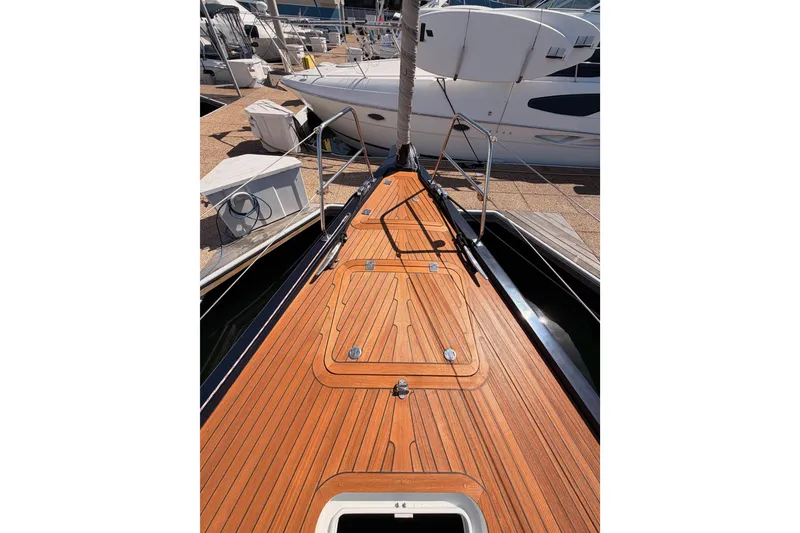Slide: The Image of 2017 Solaris 50 yacht with sleek wooden deck, docked at marina. - 19