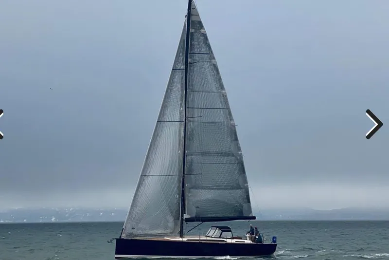 Slide: The Image of 2017 Solaris 50 sailboat on open water under a cloudy sky. - 2