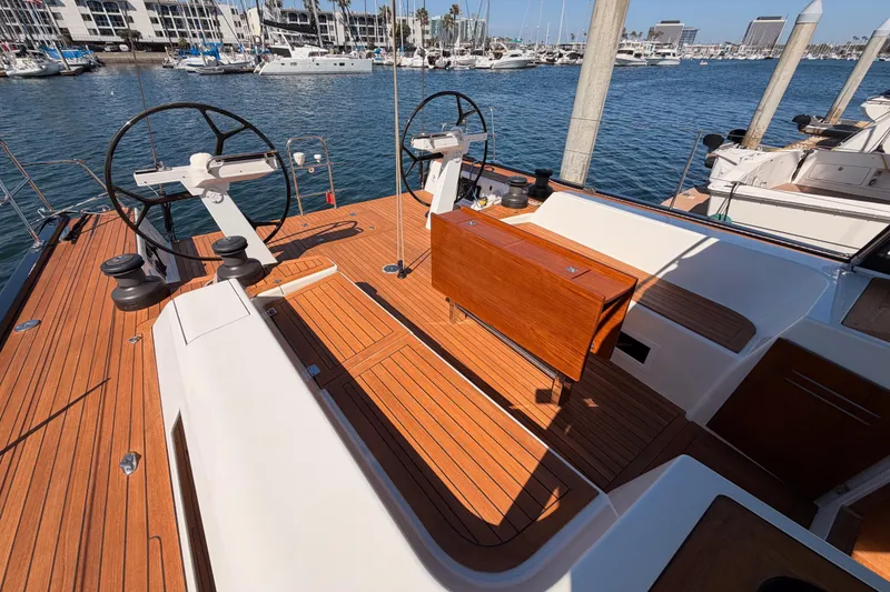 Slide: The Image of Luxurious 2017 Solaris 50 yacht deck with dual steering wheels in marina setting. - 31