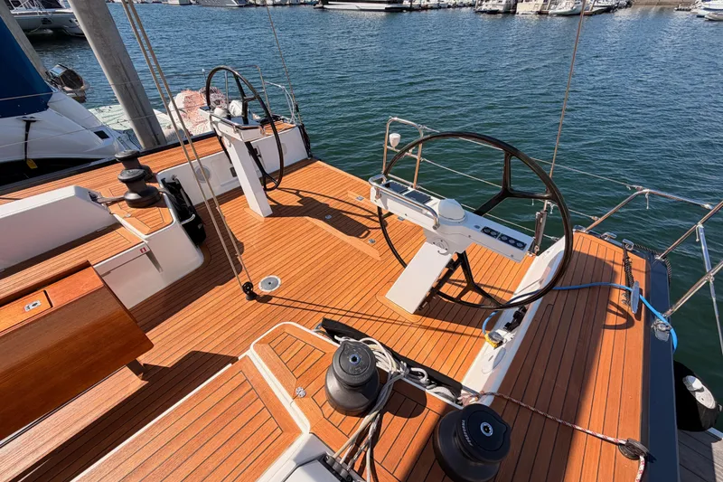 Slide: The Image of Luxurious 2017 Solaris 50 yacht deck with dual steering wheels and teak finish at marina. - 33