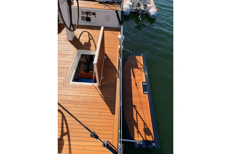 Slide: The Image of Teak deck of 2017 Solaris 50 yacht with open hatch and docked dinghy. - 39