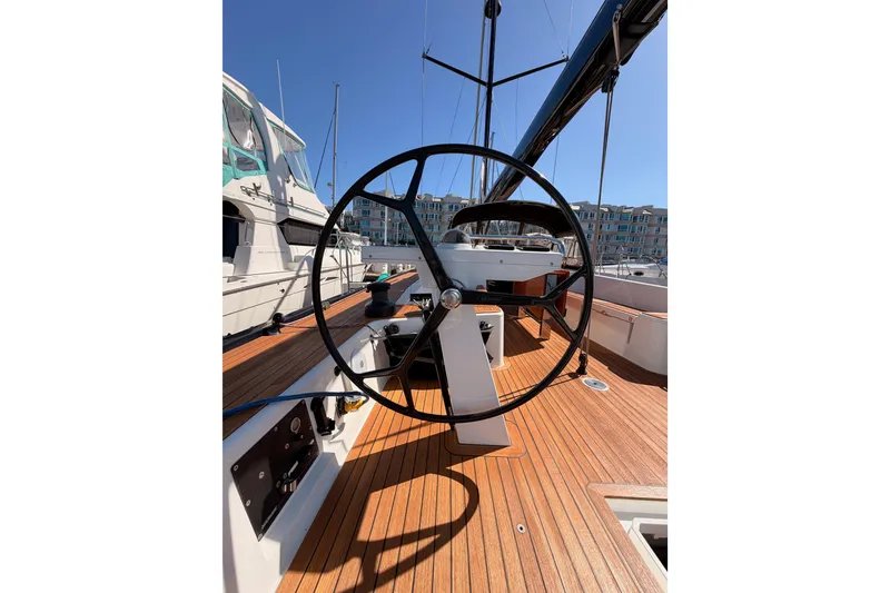 Slide: The Image of Steering wheel of a 2017 Solaris 50 yacht with wooden deck in marina. - 44