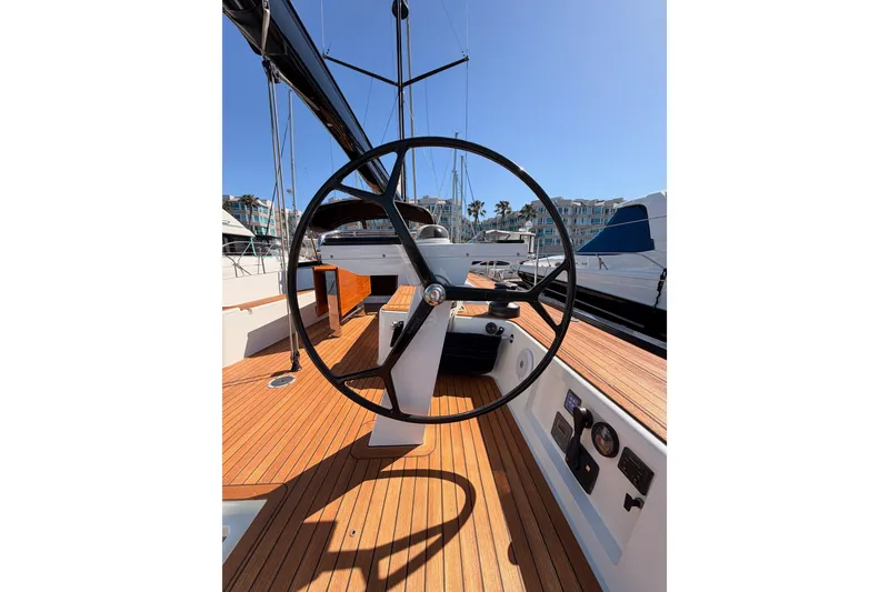 Slide: The Image of Steering wheel of a 2017 Solaris 50 yacht, docked in a sunny marina. - 46