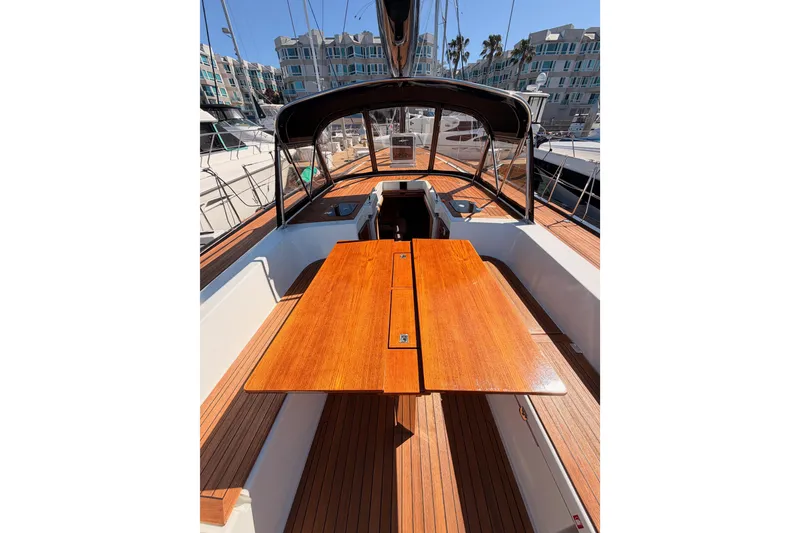 Slide: The Image of Cockpit view of 2017 Solaris 50 yacht with wooden table and marina backdrop. - 56