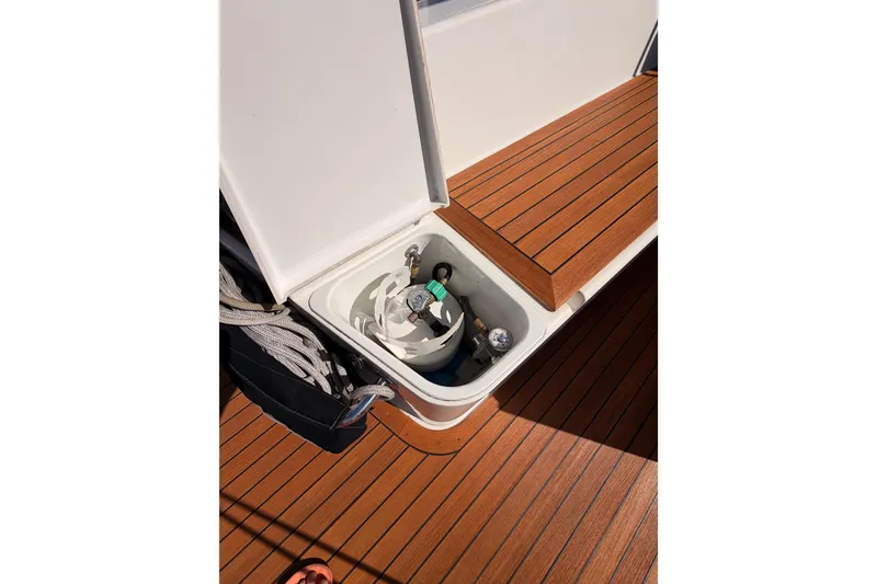 Slide: The Image of Open storage compartment on 2017 Solaris 50 yacht with wooden deck and coiled ropes. - 57