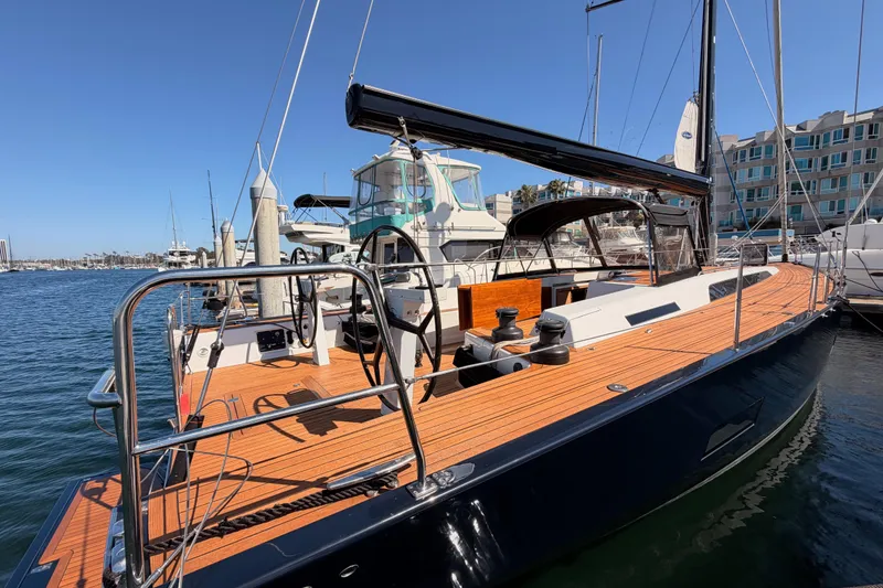 Slide: The Image of 2017 Solaris 50 yacht docked at marina, featuring sleek design and wooden deck. - 6