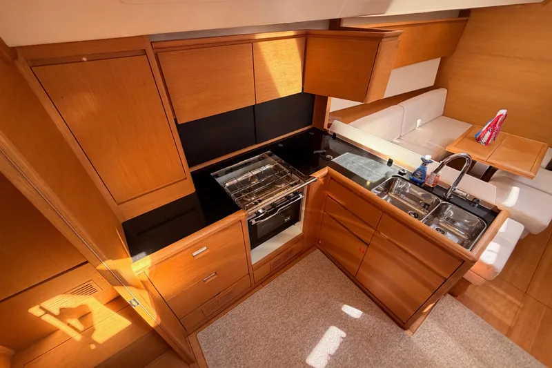 Slide: The Image of Luxurious kitchen interior of 2017 Solaris 50 yacht with wooden cabinetry and modern appliances. - 64