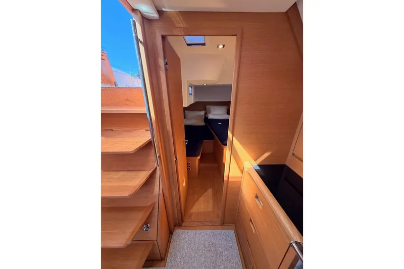 Slide: The Image of Interior of 2017 Solaris 50 yacht, featuring wooden cabinetry and cozy sleeping quarters. - 72