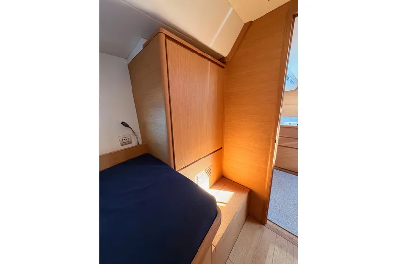 Slide: The Image of Cozy interior cabin of 2017 Solaris 50 yacht with wooden finish and blue bedding. - 76