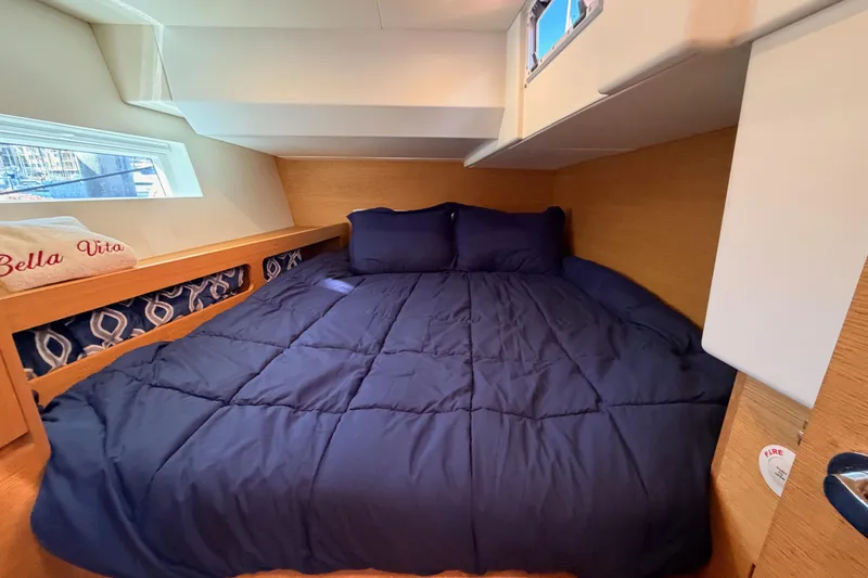 Slide: The Image of Cozy cabin bedroom in 2017 Solaris 50 yacht with navy bedding and natural wood accents. - 84