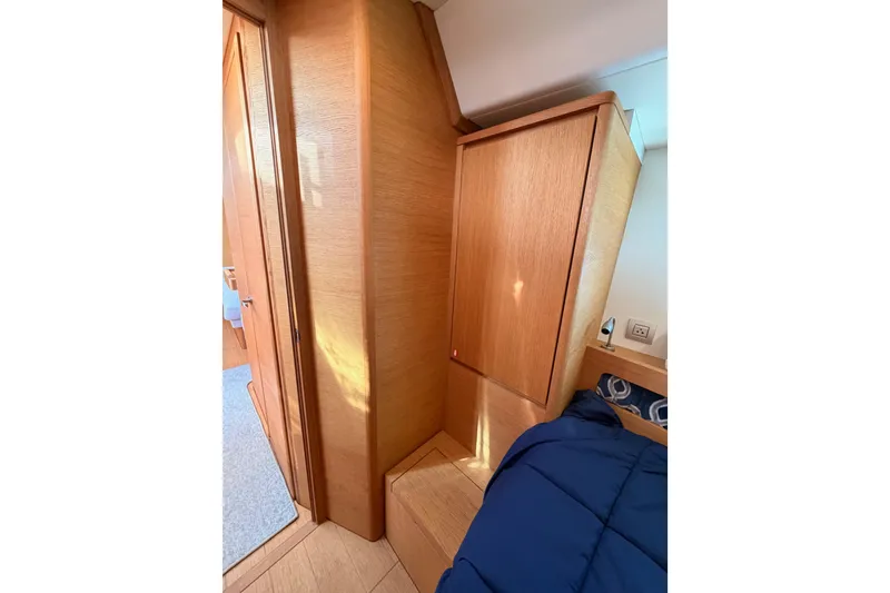 Slide: The Image of Interior of 2017 Solaris 50 yacht featuring wooden cabinetry and cozy bedding. - 85