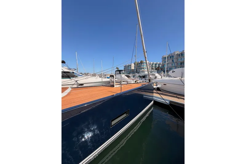 Slide: The Image of Luxurious 2017 Solaris 50 yacht docked in a marina under clear blue skies. - 9