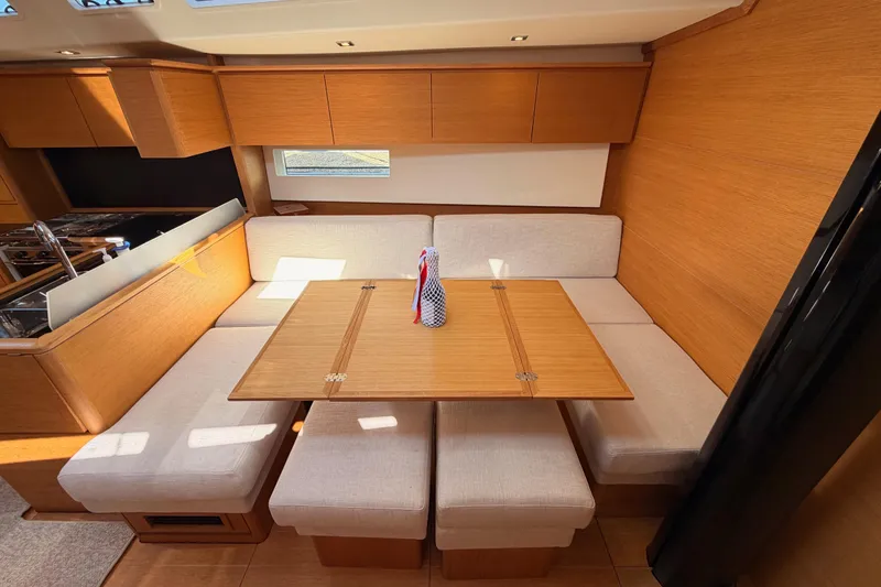 Slide: The Image of Luxurious interior of 2017 Solaris 50 yacht with wooden dining area and plush seating. - 95