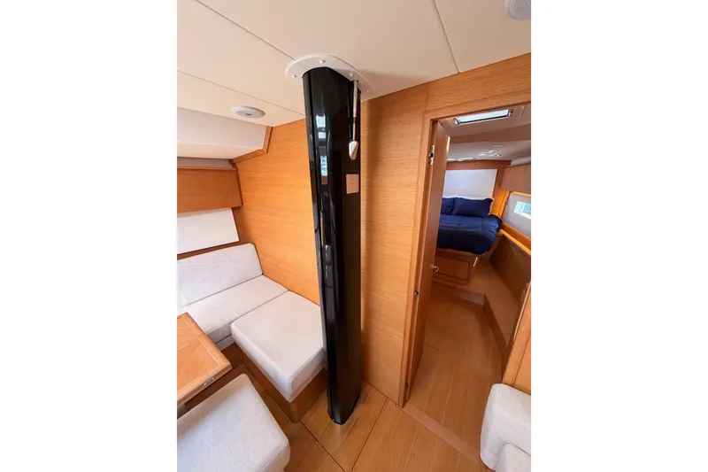 Slide: The Image of Interior of 2017 Solaris 50 yacht featuring cozy seating and a cabin with wooden finishes. - 98