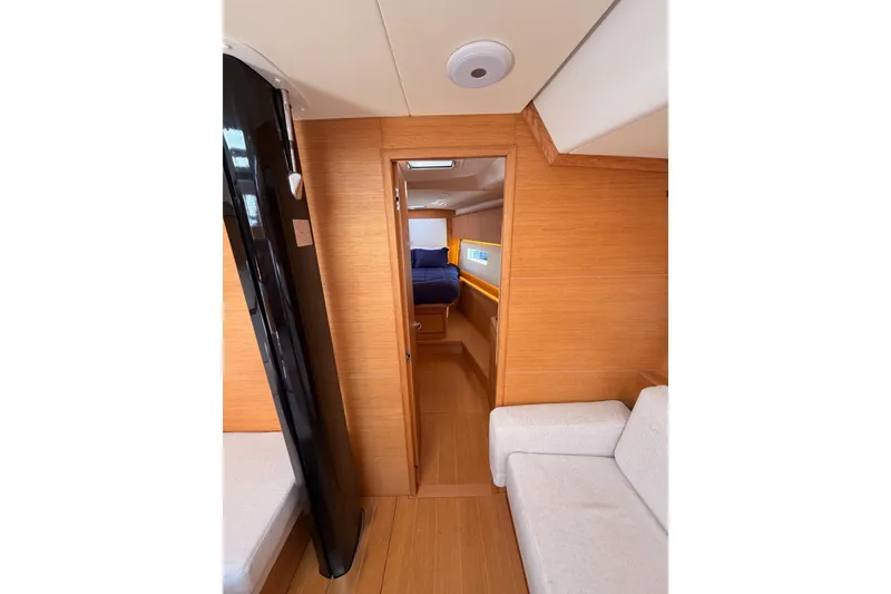 Slide: The Image of Interior of 2017 Solaris 50 yacht, featuring wooden paneling and cozy seating area. - 99