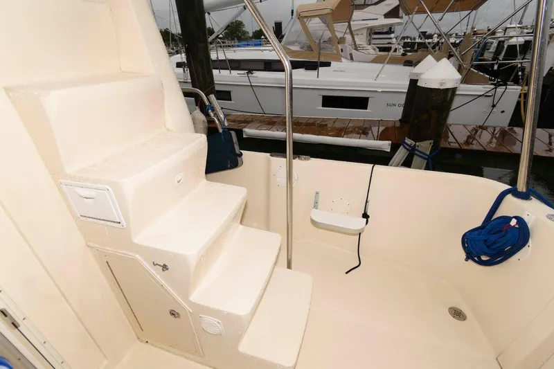 Slide: The Image of Mainship 400 Trawler 2005, stair area with railing, marina in background. - 12