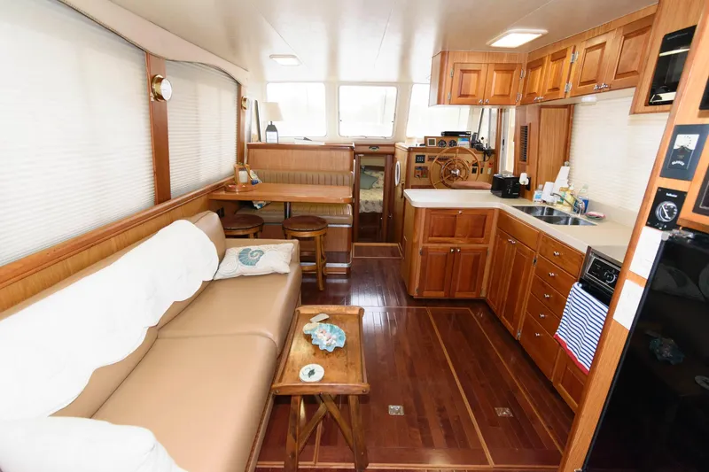 Slide: The Image of Interior of a 2005 Mainship 400 Trawler yacht with wooden furnishings. - 13