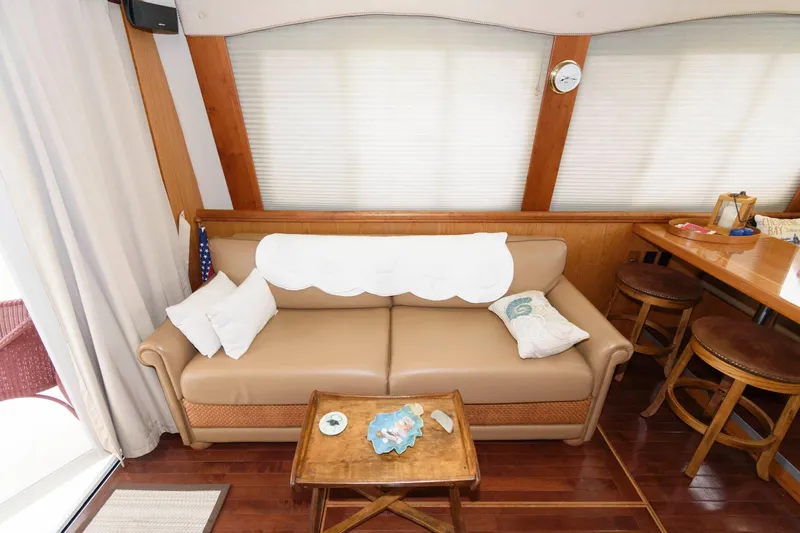 Slide: The Image of Interior of 2005 Mainship 400 Trawler with sofa and wooden table. - 14